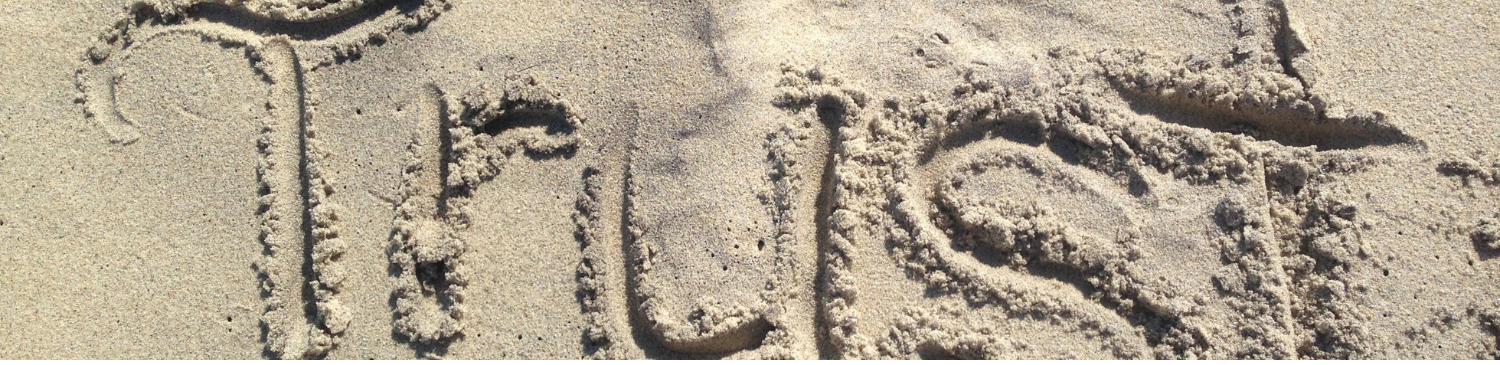 Image of the word trust written in sand. Have faith-trust God.